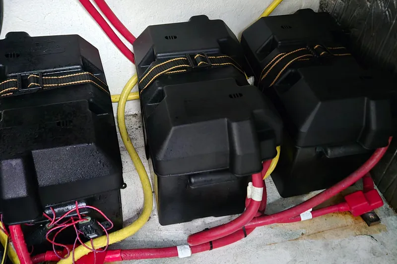 Slide: The Image of Three battery boxes with cables in a 2007 Bayliner 325 boat. - 43