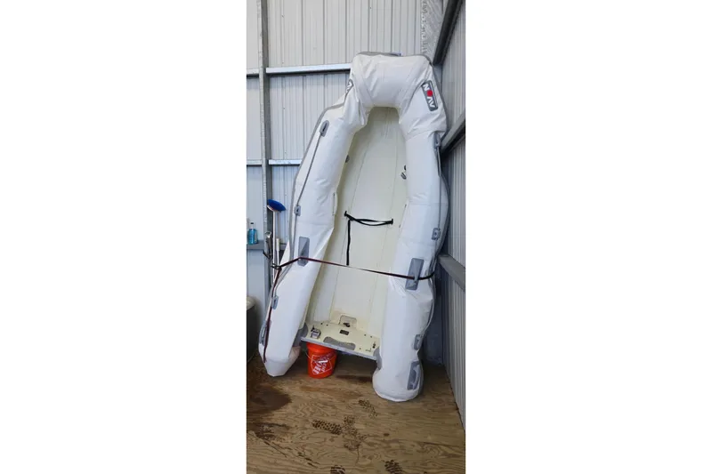 Slide: The Image of Inflatable boat stored vertically in a shed, next to a Bayliner 325, 2007 model. - 44