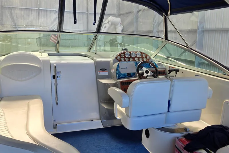 Slide: The Image of 2007 Bayliner 325 boat interior with steering wheel and seating area. - 6
