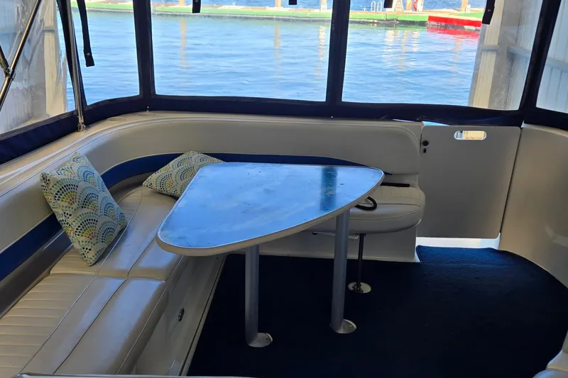 Slide: The Image of Interior of 2007 Bayliner 325 boat with seating, table, and decorative pillows. - 8