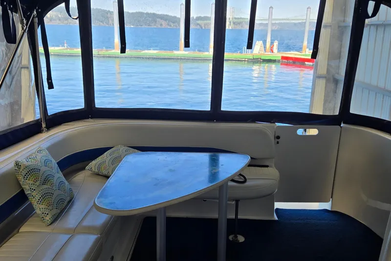 Slide: The Image of Interior of 2007 Bayliner 325 boat with seating and table, overlooking water. - 9