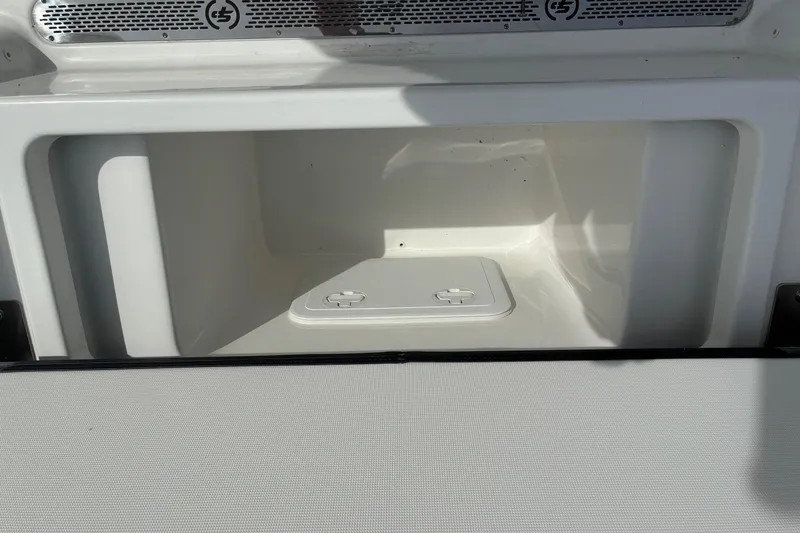 Slide: The Image of Storage compartment of 2026 Sea Pro 250 Bay boat, featuring a sleek white interior. - 13