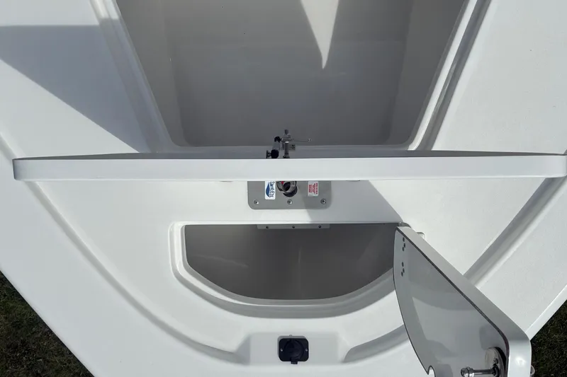Slide: The Image of 2026 Sea Pro 250 Bay boat storage compartment with open hatch, showcasing interior space. - 19