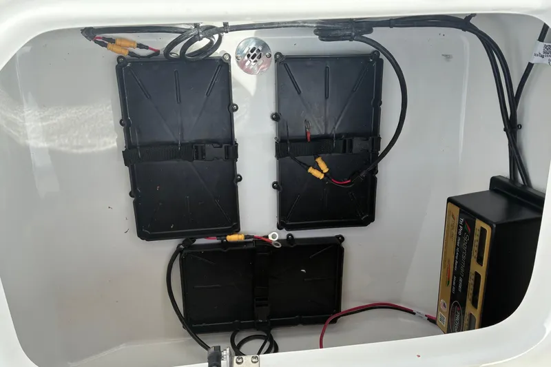 Slide: The Image of Battery compartment of a 2026 Sea Pro 250 Bay boat with wiring and components. - 20