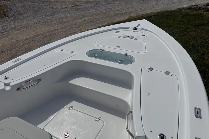 Slide: The Image of 2026 Sea Pro 250 Bay boat deck with storage compartments and seating. - 4