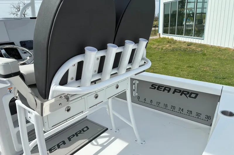 Slide: The Image of 2026 Sea Pro 250 Bay boat interior with rod holders and branded flooring. - 7