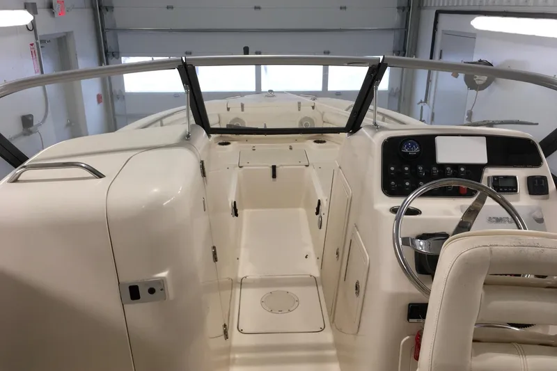 Slide: The Image of 2016 Grady-White Freedom 225 boat interior with steering wheel and control panel. - 11