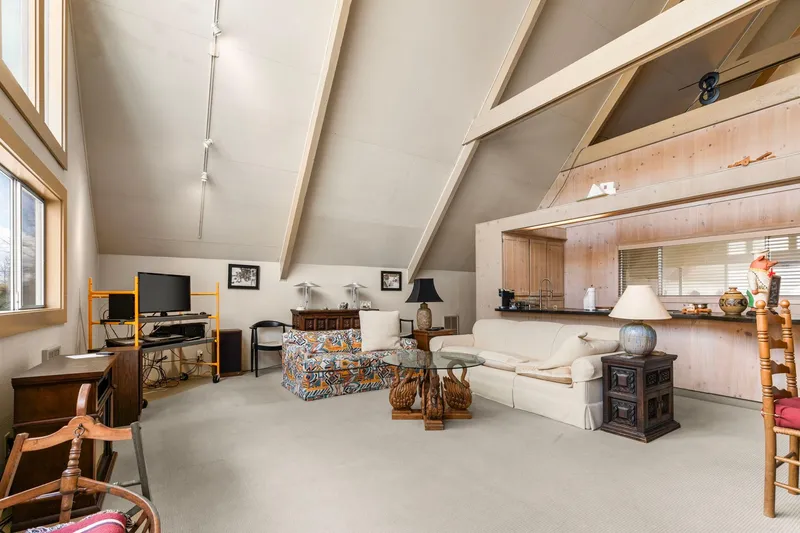 Slide: The Image of Spacious 1976 custom boathouse interior with vaulted ceilings, cozy seating, and modern decor. - 10