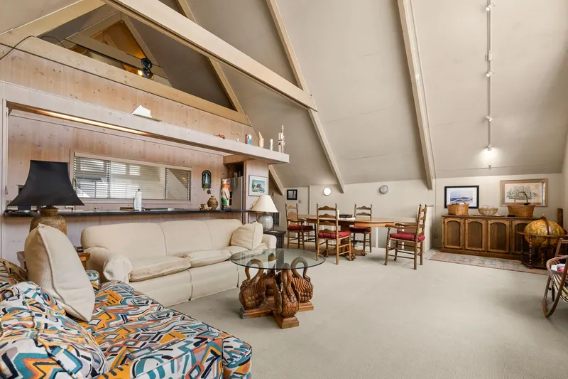 Slide: The Image of Spacious 1976 custom boathouse interior with cozy seating, dining area, and rustic decor. - 12