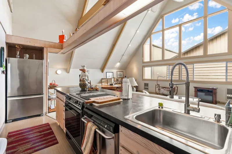 Slide: The Image of Modern kitchen in a 1976 custom boathouse with vaulted ceilings and large windows. - 15