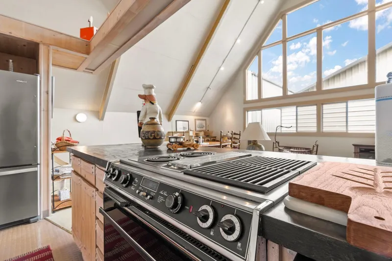 Slide: The Image of A-frame boathouse kitchen with modern appliances and large windows, built in 1976. - 16