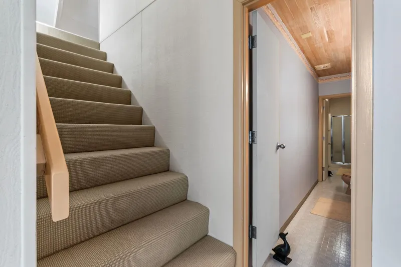 Slide: The Image of Carpeted staircase and hallway in a 1976 custom boathouse interior. - 20