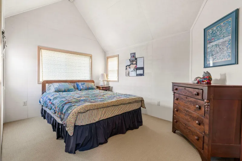Slide: The Image of Cozy bedroom in a 1976 custom boathouse with colorful bedding and wooden dresser. - 24