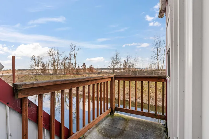 Slide: The Image of Wooden balcony overlooking serene water and trees, Custom Boathouse, 1976. - 26