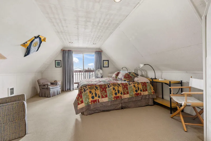 Slide: The Image of Cozy attic bedroom with colorful quilt, vintage decor, and balcony view in 1976 custom boathouse. - 27
