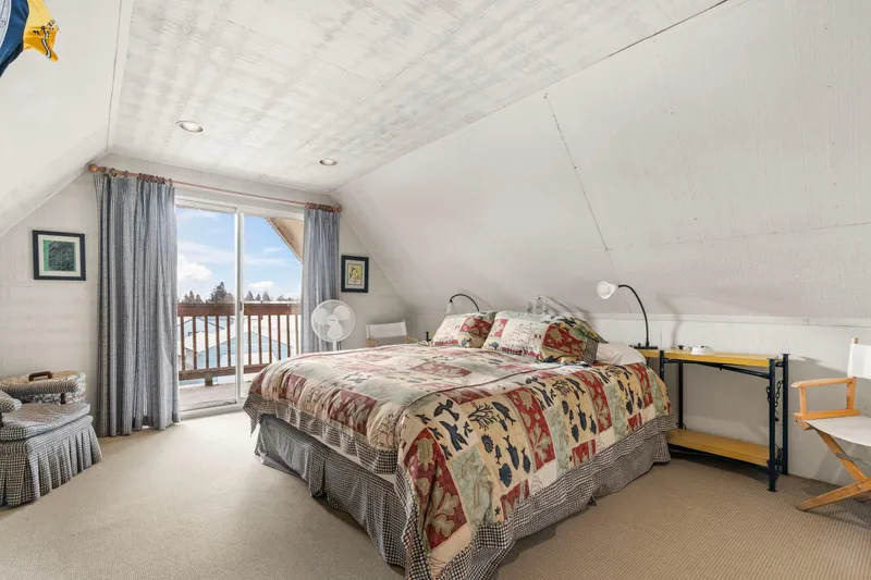 Slide: The Image of Cozy attic bedroom in 1976 custom boathouse with quilted bedspread and balcony view. - 28