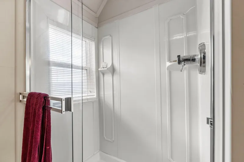 Slide: The Image of Modern shower with glass door, red towel, and chrome fixtures in a 1976 Custom Boathouse. - 34