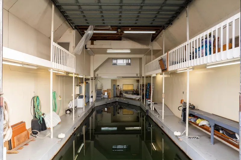 Slide: The Image of Interior of a 1976 custom boathouse with water channel and storage areas. - 38