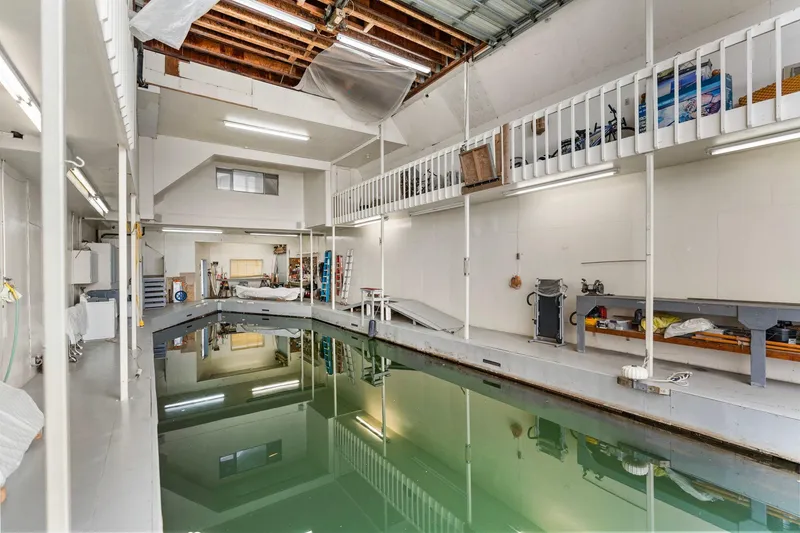 Slide: The Image of Interior of a 1976 custom boathouse with indoor water dock and storage area. - 40