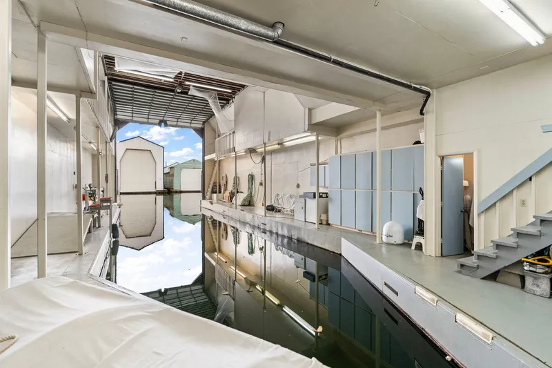 Slide: The Image of Interior of a 1976 custom boathouse with waterway and storage area. - 41