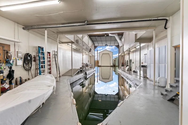 Slide: The Image of Interior of a 1976 custom boathouse with water channel and storage area. - 42