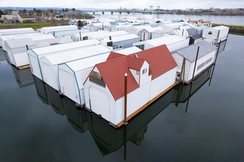 Slide: The Image of Floating boathouses with red roofs on calm water, Custom model, 1976. - 48