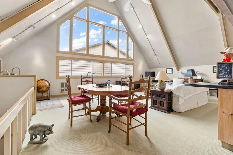 Slide: The Image of Spacious 1976 custom boathouse interior with vaulted ceilings, large windows, and elegant dining area. - 7