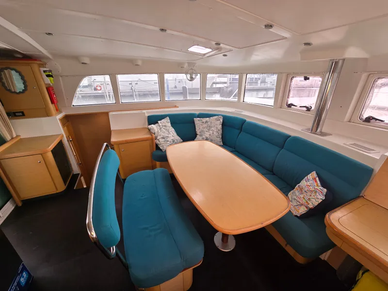 Slide: The Image of Interior of a 2007 Lagoon 440 yacht with blue seating. - 10