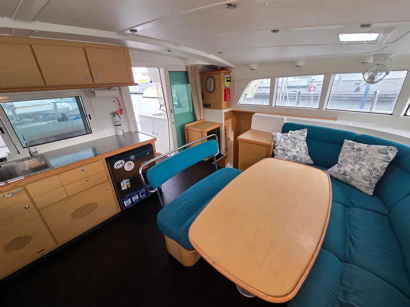 Slide: The Image of Interior of a 2007 Lagoon 440 yacht with kitchen and seating area. - 11