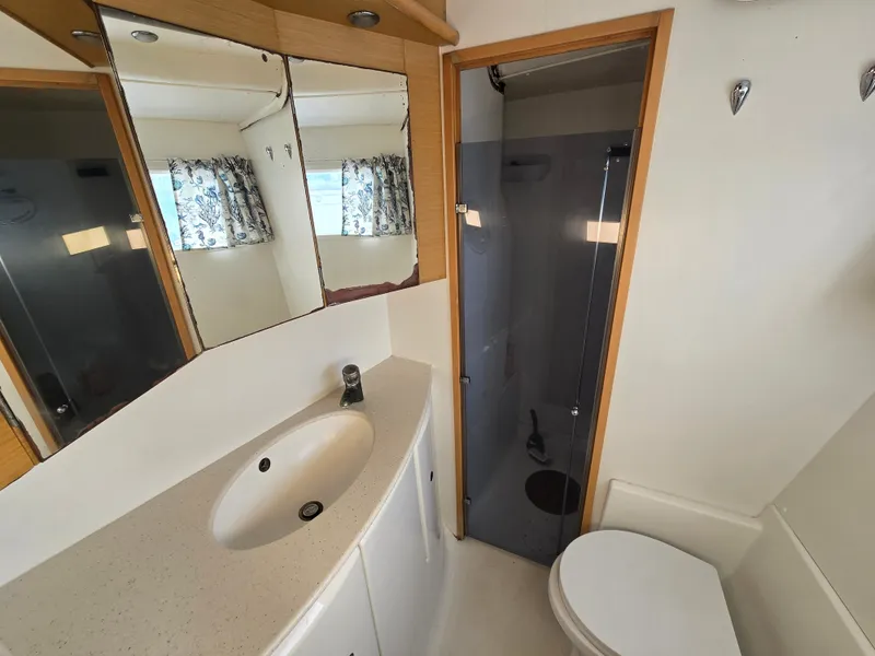 Slide: The Image of Bathroom of a 2007 Lagoon 440 yacht with shower and sink. - 19