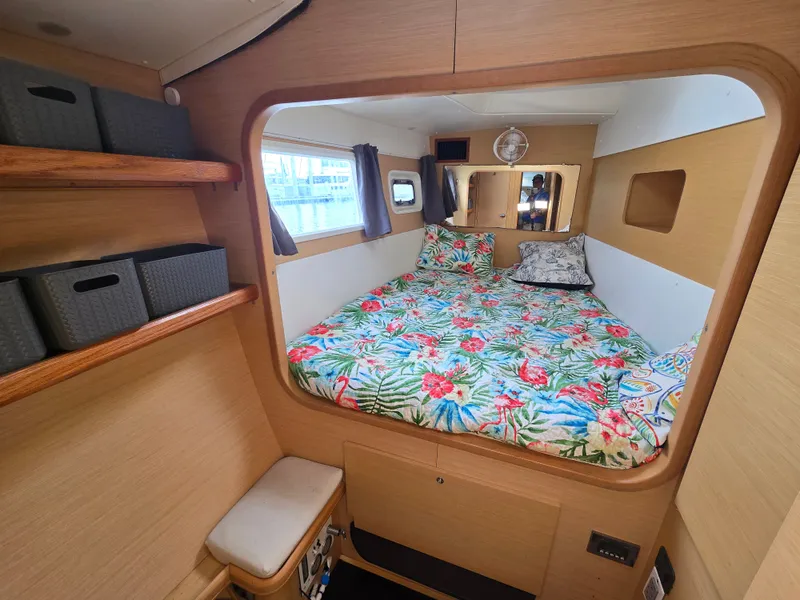 Slide: The Image of Interior of a Lagoon 440 yacht with cozy bed and shelves. - 22