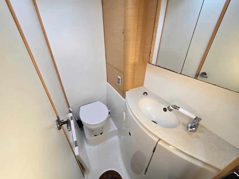 Slide: The Image of Lagoon 440 yacht bathroom, 2007 model, featuring toilet and sink. - 24