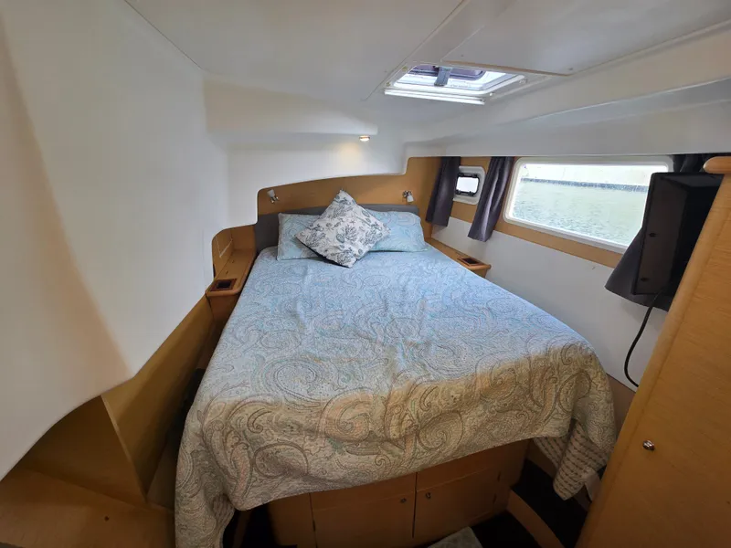 Slide: The Image of Interior of Lagoon 440 yacht, cozy bedroom with window view. - 25