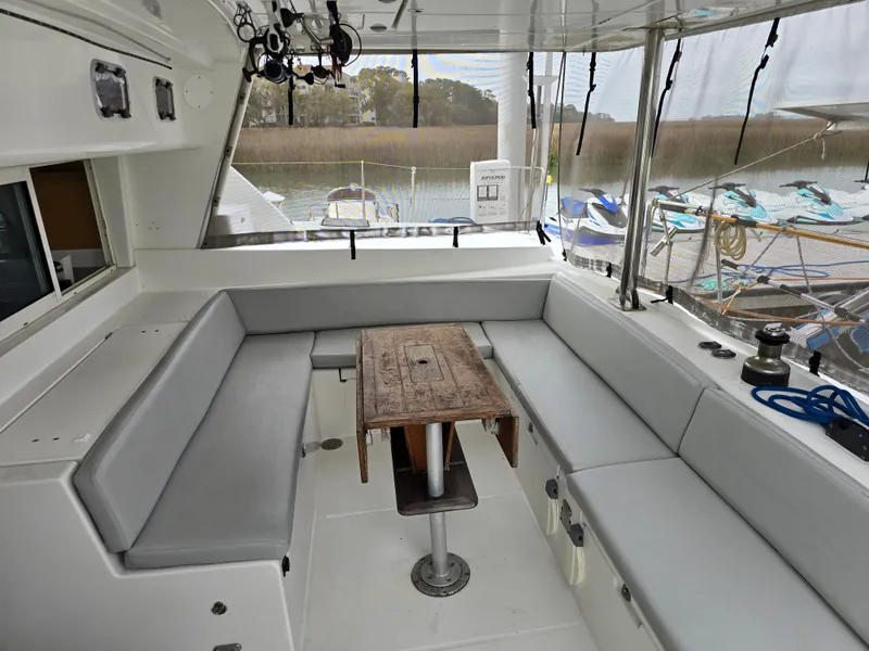 Slide: The Image of Interior of a 2007 Lagoon 440 yacht with gray seating cushions. - 7