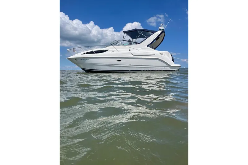 The Image of 2000 Bayliner 3055 Ciera boat on water under blue sky with clouds. - 0