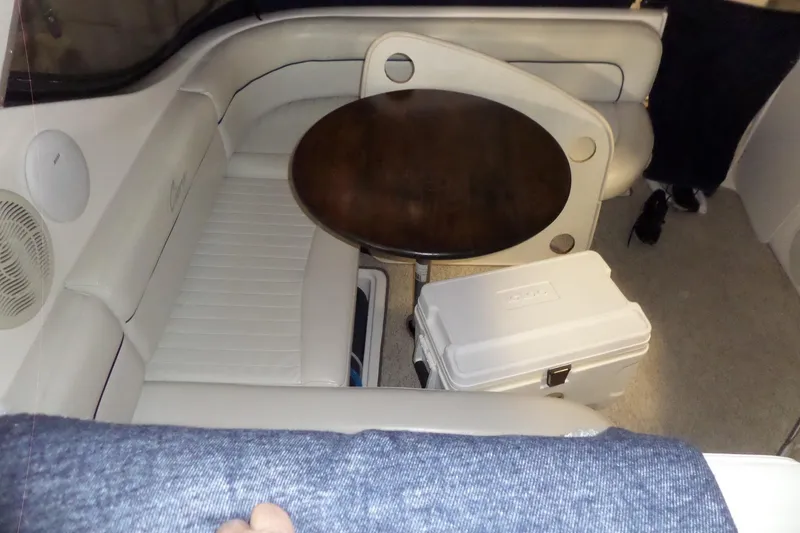 Slide: The Image of Interior of 2000 Bayliner 3055 Ciera with seating, table, and cooler. - 16
