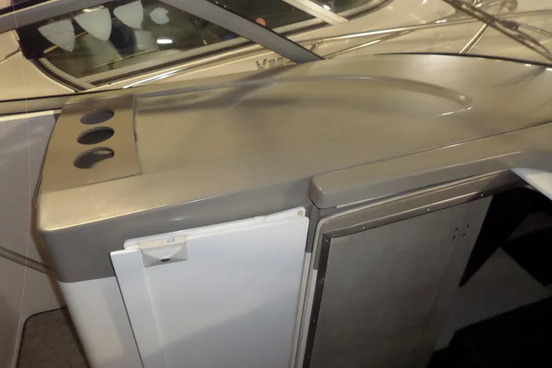 Slide: The Image of Interior view of a 2000 Bayliner 3055 Ciera boat, featuring a sleek countertop and storage area. - 17