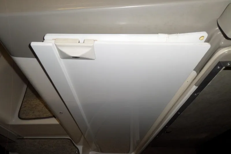 Slide: The Image of Interior detail of a 2000 Bayliner 3055 Ciera boat, featuring a white folding door. - 18