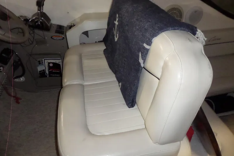 Slide: The Image of Interior of 2000 Bayliner 3055 Ciera boat with white seating and nautical-themed blanket. - 19