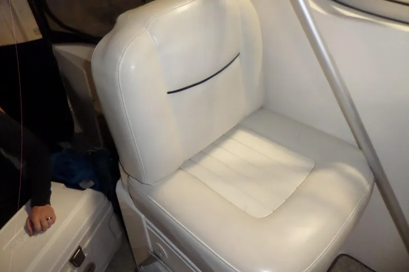 Slide: The Image of White leather seat inside a 2000 Bayliner 3055 Ciera boat cabin. - 21