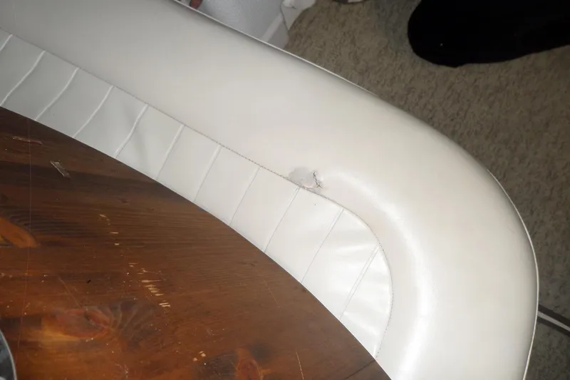 Slide: The Image of White leather seat with a tear on a Bayliner 3055 Ciera, 2000 model. - 22