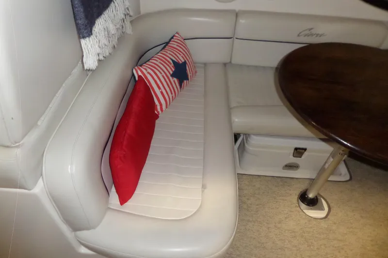 Slide: The Image of Interior of 2000 Bayliner 3055 Ciera with white seating and decorative pillows. - 27