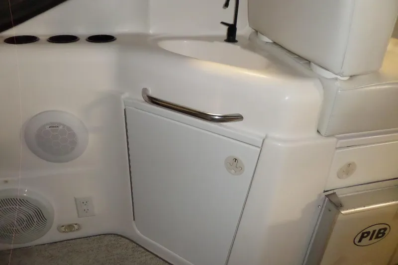 Slide: The Image of Interior of a 2000 Bayliner 3055 Ciera boat, featuring a sink and storage area. - 30