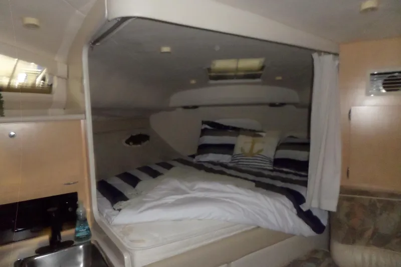 Slide: The Image of Interior cabin of a 2000 Bayliner 3055 Ciera with cozy bedding and nautical decor. - 32