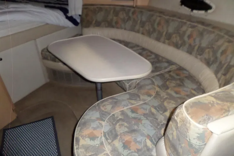 Slide: The Image of Interior of 2000 Bayliner 3055 Ciera with patterned seating and table. - 34