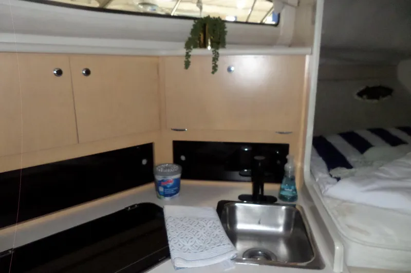 Slide: The Image of Interior of 2000 Bayliner 3055 Ciera showing kitchenette with sink and cabinets. - 35