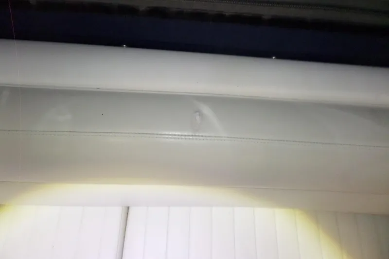 Slide: The Image of Interior detail of a 2000 Bayliner 3055 Ciera boat, featuring white upholstery. - 4