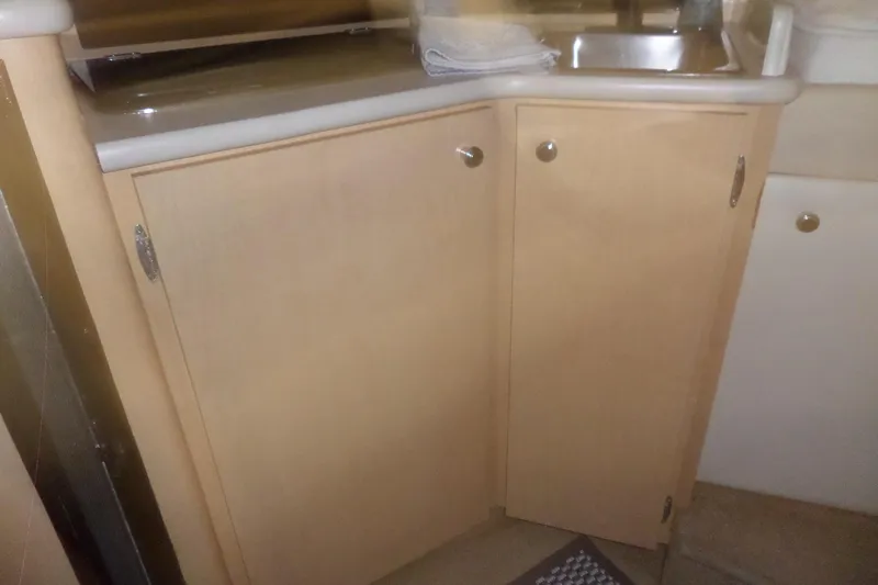 Slide: The Image of Interior view of 2000 Bayliner 3055 Ciera kitchen area with cabinets and sink. - 41