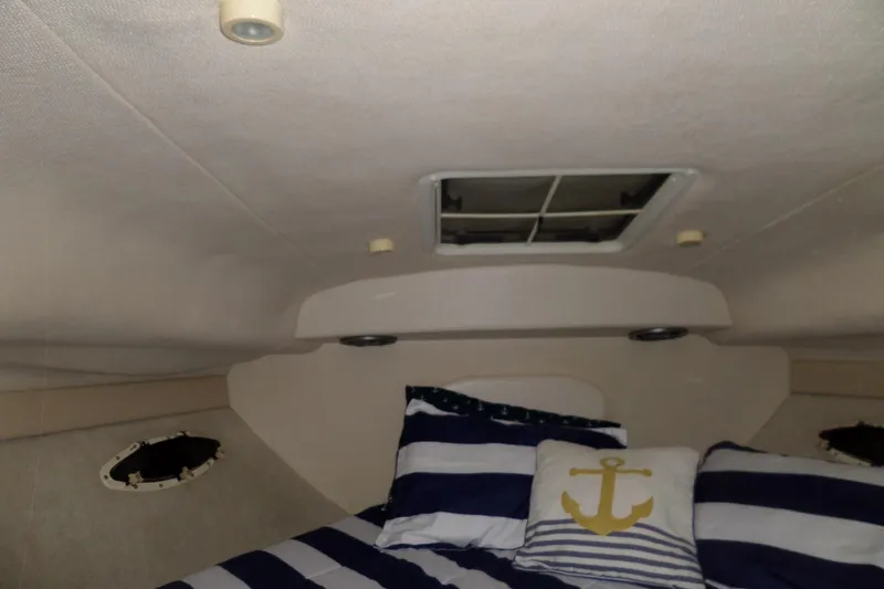 Slide: The Image of Interior cabin of 2000 Bayliner 3055 Ciera with nautical-themed bedding. - 43