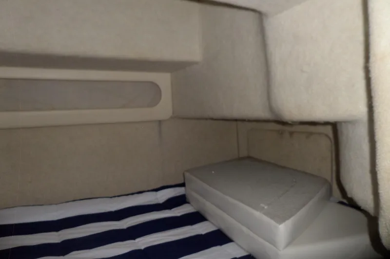 Slide: The Image of Interior cabin of 2000 Bayliner 3055 Ciera with striped bedding and cushions. - 48